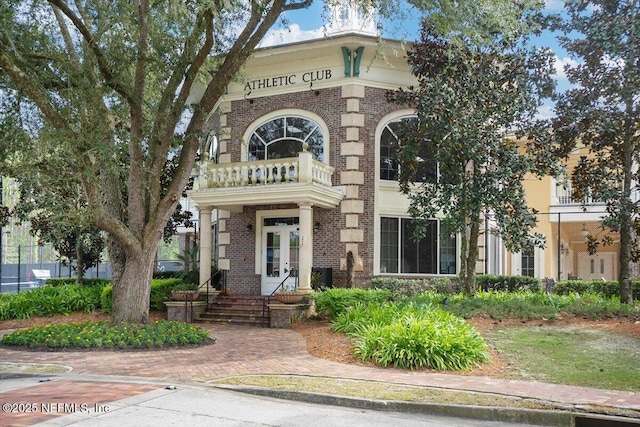 982 Oakland Hills Ave, Middleburg, FL 32068 - view of front facade with french doors, a balcony, and brick siding
