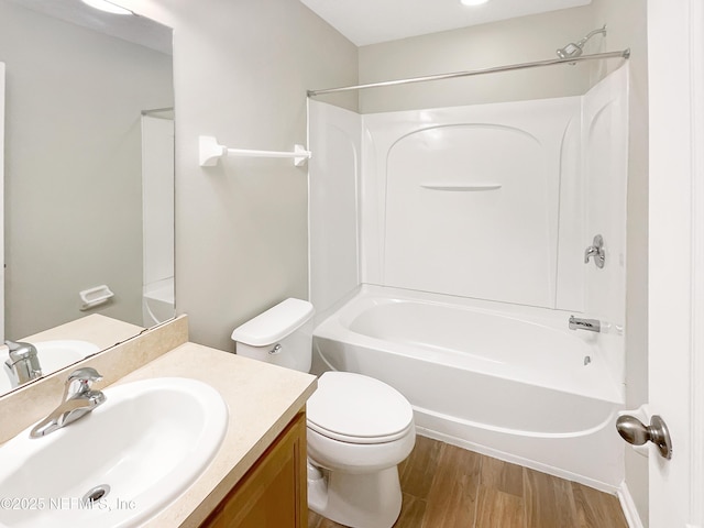 bathroom with vanity, wood finished floors, toilet, and bathtub / shower combination