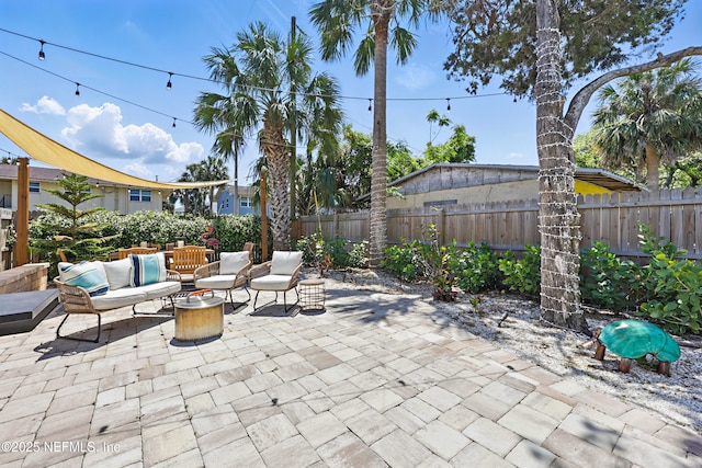 view of patio featuring an outdoor living space and a fenced backyard