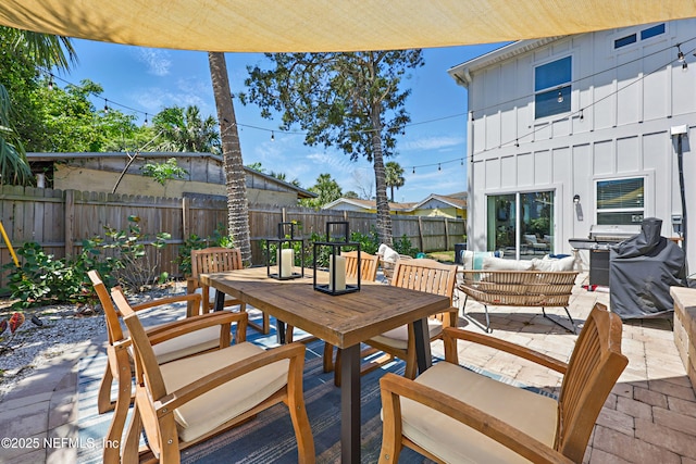 view of patio / terrace with outdoor dining area, a fenced backyard, and an outdoor hangout area