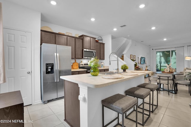 kitchen featuring appliances with stainless steel finishes, light countertops, a sink, visible vents, and light tile patterned flooring