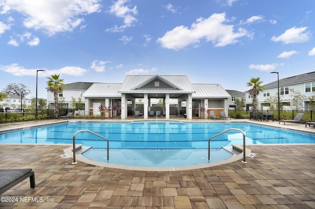 pool featuring a patio and fence
