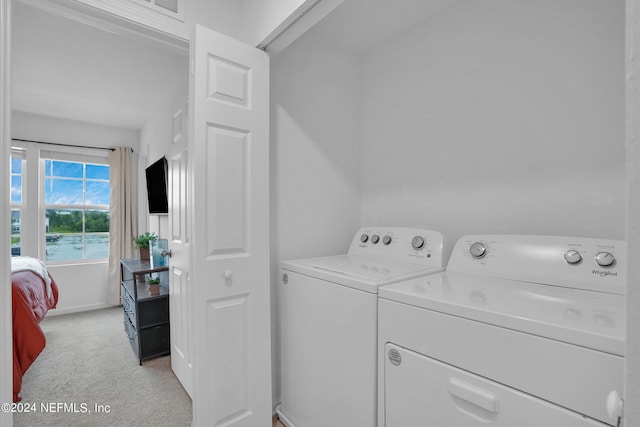 washroom with separate washer and dryer, baseboards, laundry area, and light carpet