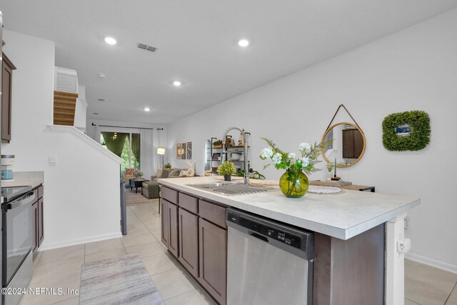 kitchen featuring range with electric stovetop, light countertops, dishwasher, a sink, and visible vents
