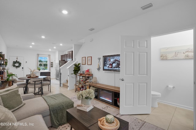 living room with recessed lighting, stairway, light tile patterned floors, visible vents, and baseboards