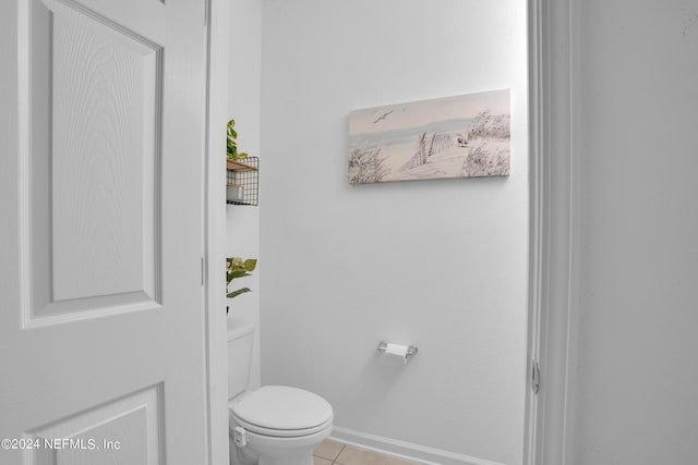 bathroom featuring toilet and tile patterned flooring