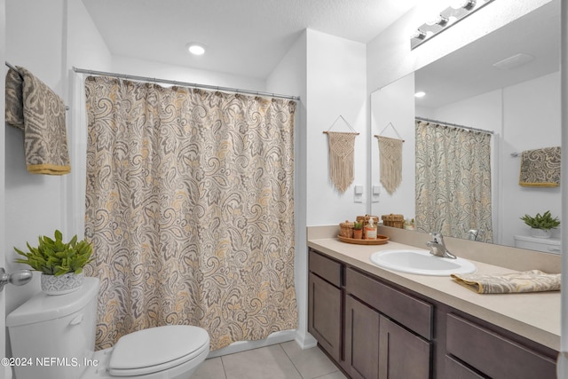full bath with toilet, tile patterned flooring, and vanity