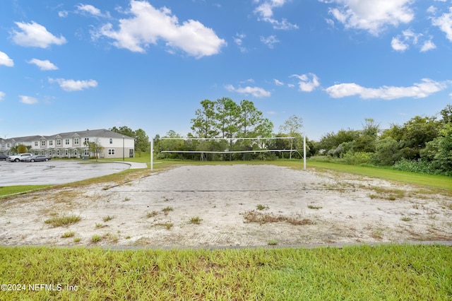 view of home's community with a lawn and volleyball court