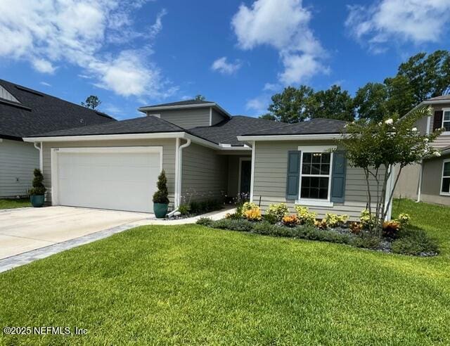 view of front of house with a garage, driveway, and a front yard