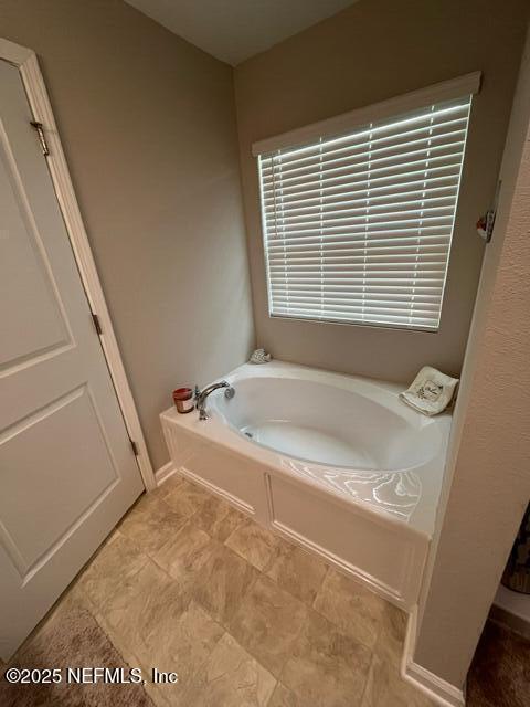bathroom with a garden tub