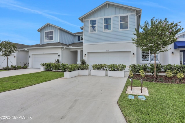 view of front facade with a front lawn, concrete driveway, and an attached garage