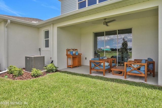 exterior space with a yard, ceiling fan, central AC unit, and a patio
