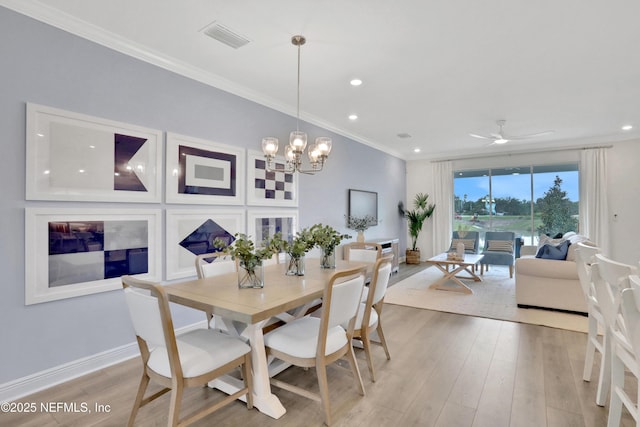dining area with recessed lighting, crown molding, visible vents, light wood-style flooring, and ceiling fan with notable chandelier