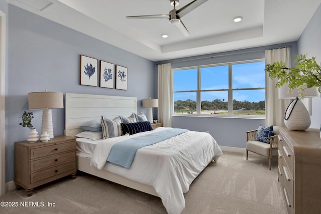 carpeted bedroom featuring recessed lighting, a ceiling fan, a raised ceiling, and baseboards