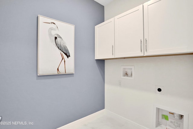 clothes washing area with baseboards, hookup for a washing machine, cabinet space, and hookup for an electric dryer