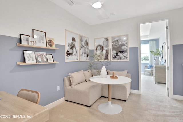 living area featuring carpet and baseboards