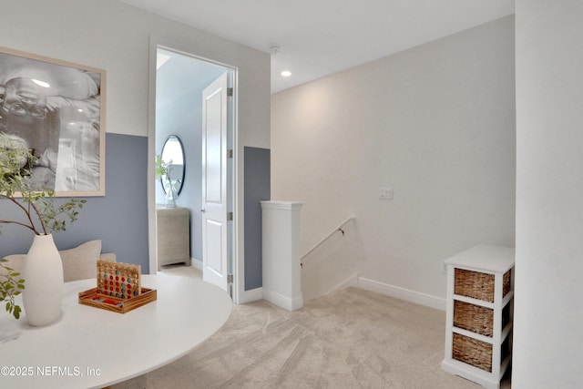 corridor with an upstairs landing, carpet, and baseboards
