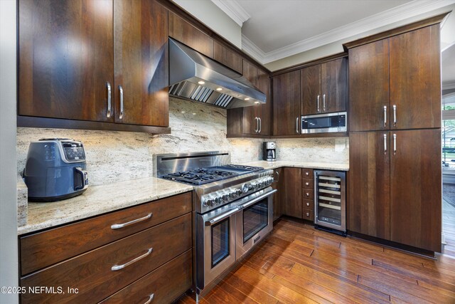 kitchen with tasteful backsplash, range hood, beverage cooler, ornamental molding, and stainless steel appliances