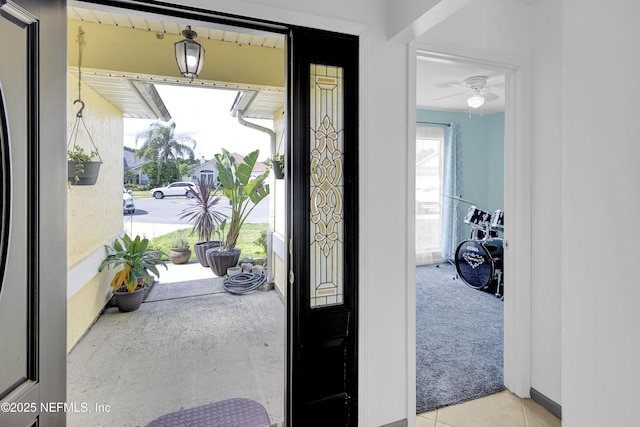 1558 Roseberry Ct, Fleming Island, FL 32003 - foyer entrance with light tile patterned floors, a ceiling fan, and light carpet