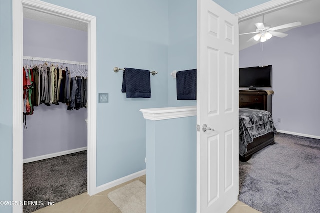 1558 Roseberry Ct, Fleming Island, FL 32003 - bathroom featuring a walk in closet, ceiling fan, and baseboards