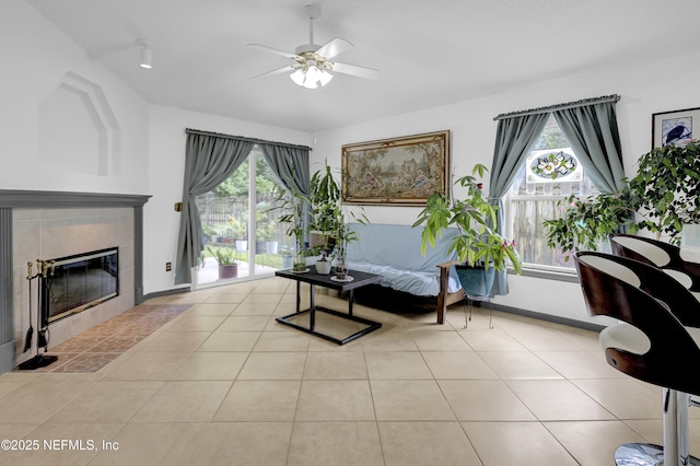 1558 Roseberry Ct, Fleming Island, FL 32003 - sitting room featuring baseboards, light tile patterned flooring, ceiling fan, and a tile fireplace
