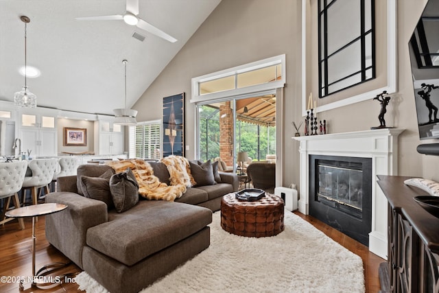 1576 Linkside Dr, Fleming Island, FL 32003 - living room with high vaulted ceiling, ceiling fan, a glass covered fireplace, dark wood-style flooring, and healthy amount of natural light