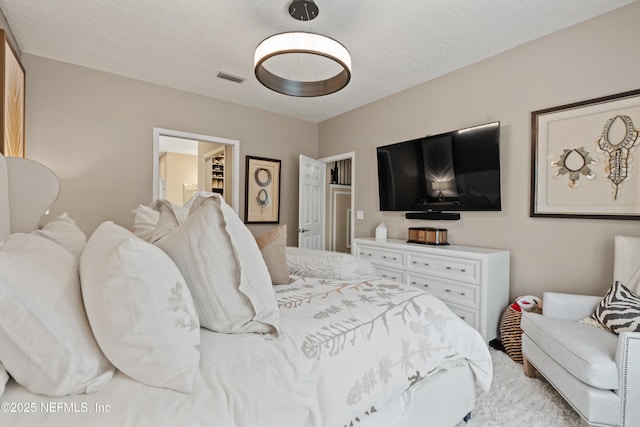 1576 Linkside Dr, Fleming Island, FL 32003 - bedroom featuring a walk in closet, light colored carpet, and a textured ceiling