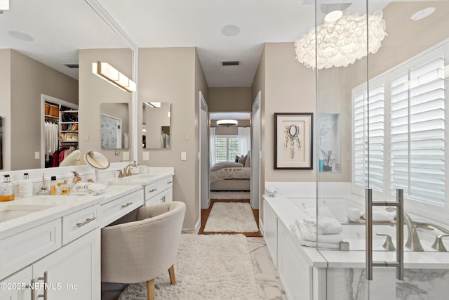 1576 Linkside Dr, Fleming Island, FL 32003 - full bath featuring a bath, double vanity, connected bathroom, marble finish flooring, and a walk in closet