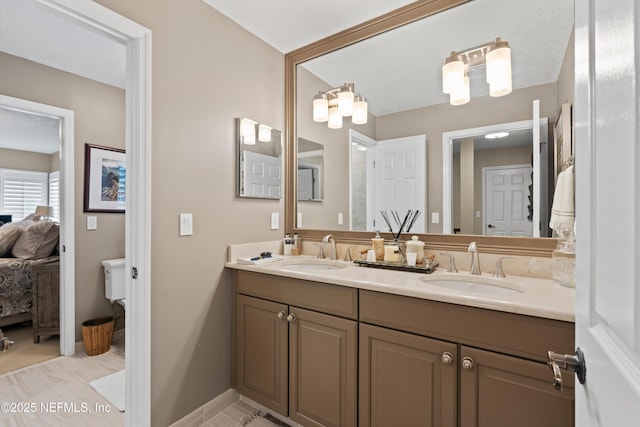 1576 Linkside Dr, Fleming Island, FL 32003 - ensuite bathroom with double vanity, toilet, and baseboards