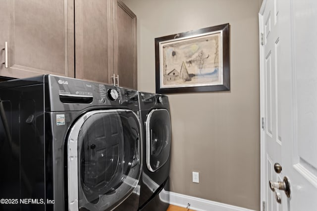 1576 Linkside Dr, Fleming Island, FL 32003 - washroom with washing machine and dryer, cabinet space, and baseboards