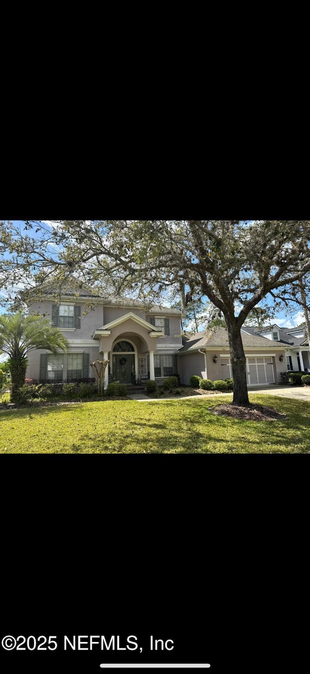 view of front of property featuring stucco siding and a front yard