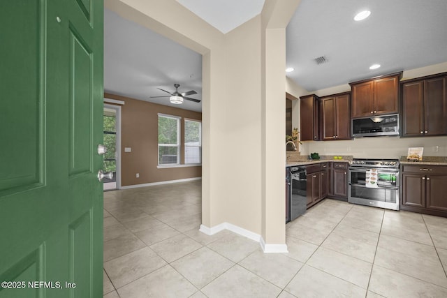 133 San Briso Way, Saint Augustine, FL 32092 - kitchen featuring stainless steel appliances, light tile patterned floors, dark brown cabinets, ceiling fan, and light stone counters
