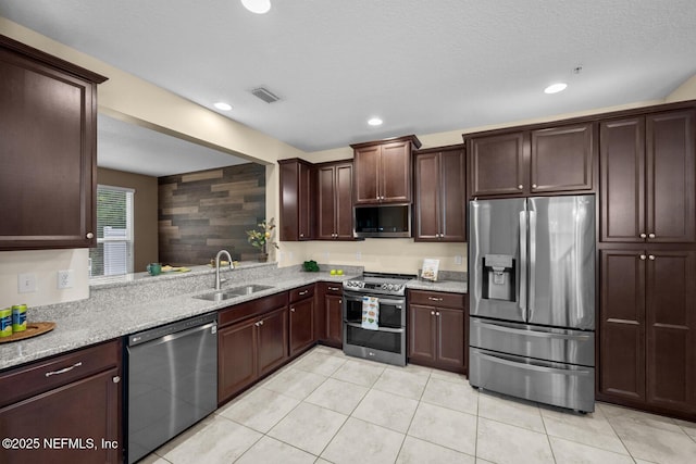 133 San Briso Way, Saint Augustine, FL 32092 - kitchen with stainless steel appliances, light tile patterned floors, light stone countertops, and recessed lighting