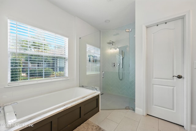 2427 Green Glade Ct, Fleming Island, FL 32003 - bathroom featuring a garden tub, a shower stall, and tile patterned floors