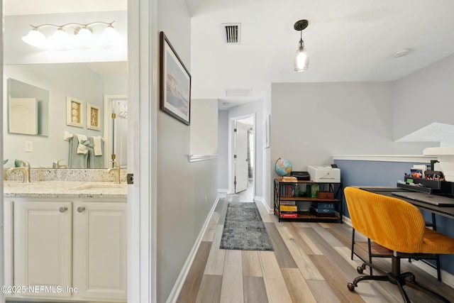 2427 Green Glade Ct, Fleming Island, FL 32003 - office space with light wood-style floors, a sink, and baseboards