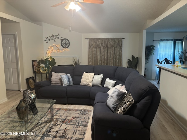 living room with ceiling fan and wood finished floors