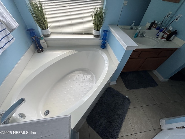 bathroom featuring a tub, vanity, and tile patterned floors