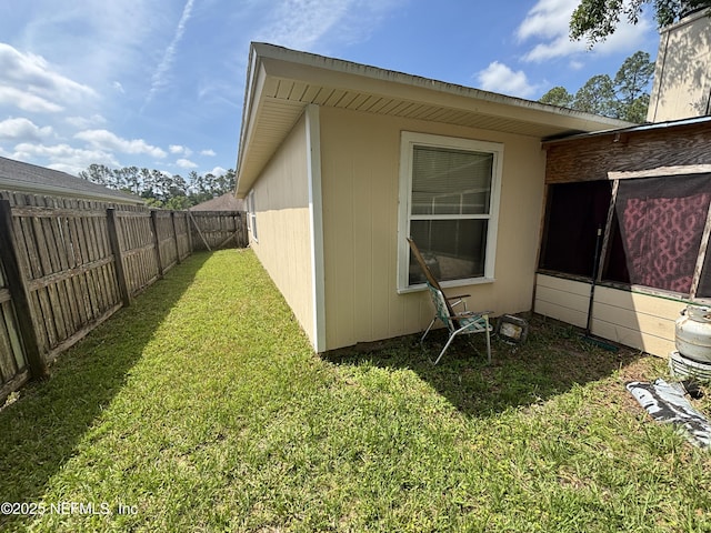 view of side of property featuring a yard and fence private yard
