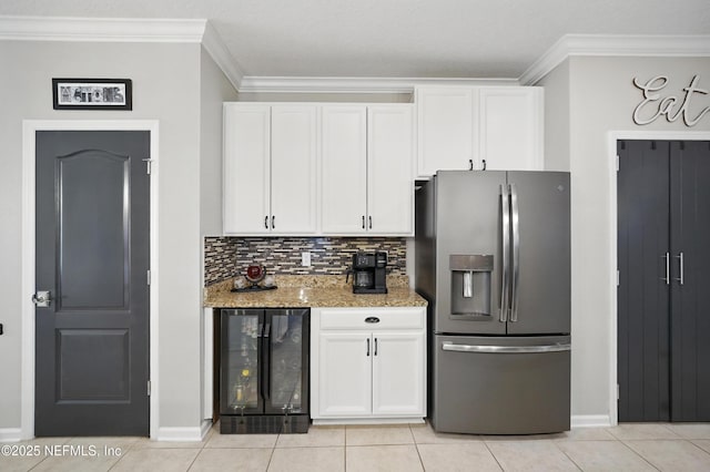 kitchen with crown molding, baseboards, wine cooler, and stainless steel fridge with ice dispenser
