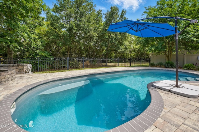view of swimming pool with a patio, a fenced in pool, and a fenced backyard