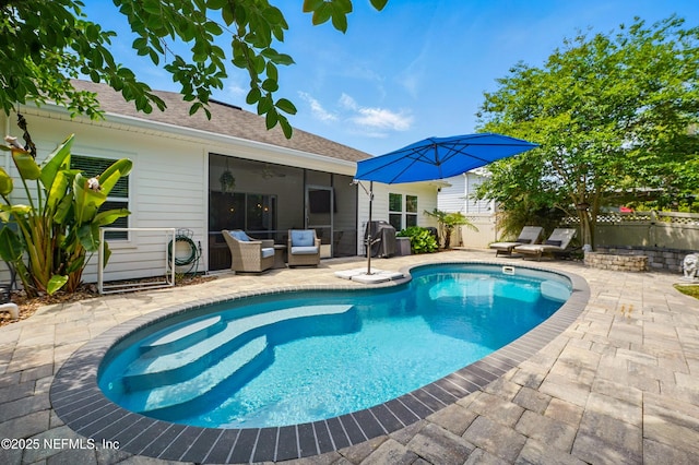 view of swimming pool featuring a patio, a fenced in pool, fence, and outdoor lounge area