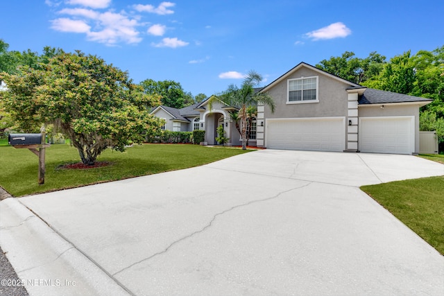 view of front of house featuring a garage, stucco siding, concrete driveway, and a front yard