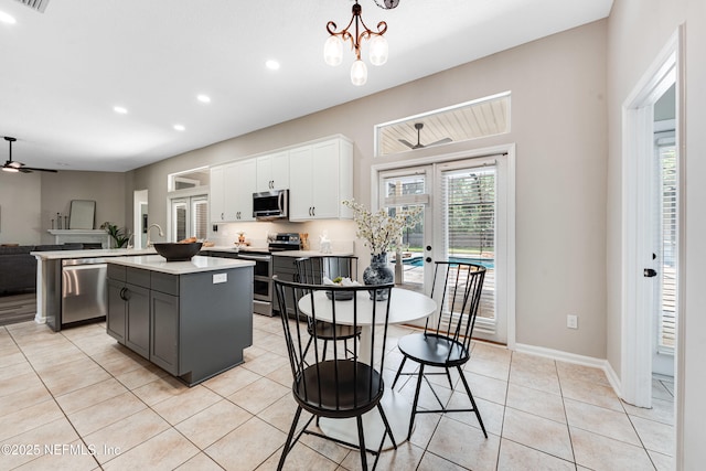 kitchen with an island with sink, recessed lighting, light countertops, white cabinets, and stainless steel appliances