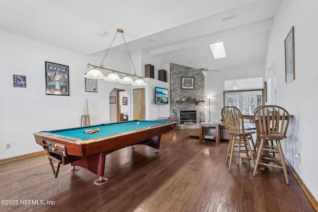playroom featuring hardwood / wood-style flooring, a brick fireplace, ceiling fan, pool table, and a skylight