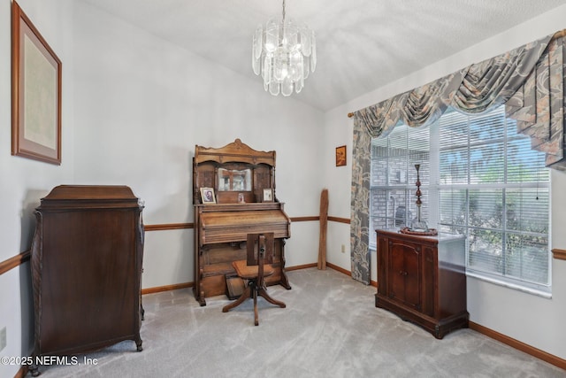 carpeted office space featuring baseboards and an inviting chandelier
