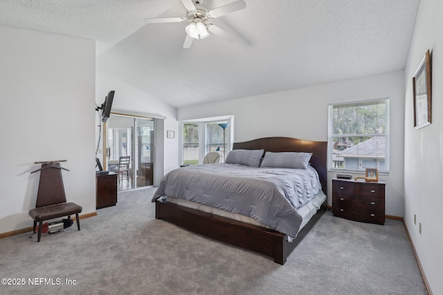 bedroom featuring a ceiling fan, carpet, baseboards, a textured ceiling, and lofted ceiling