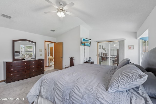 bedroom with lofted ceiling, light colored carpet, visible vents, and multiple windows