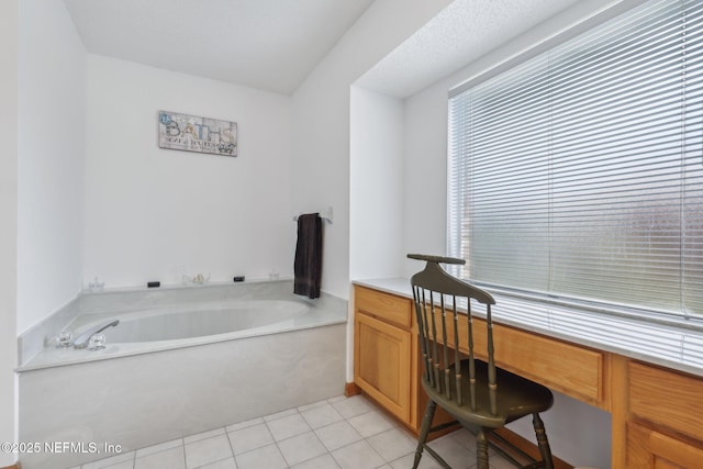 full bathroom featuring a bath and tile patterned flooring