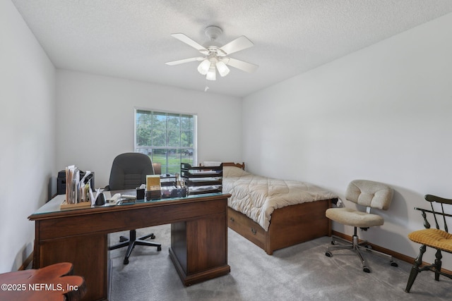 carpeted bedroom featuring a textured ceiling and a ceiling fan