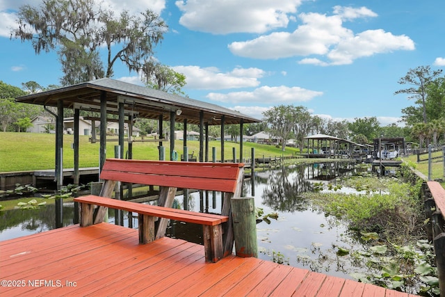 dock area featuring a yard and a water view
